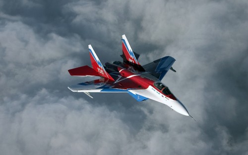 Image red and white jet plane in mid air