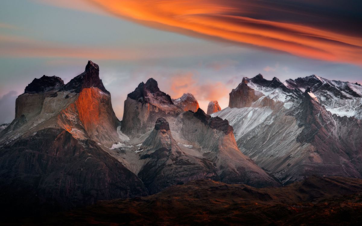 snow covered mountain during sunset