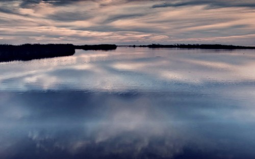 Image body of water under cloudy sky during daytime