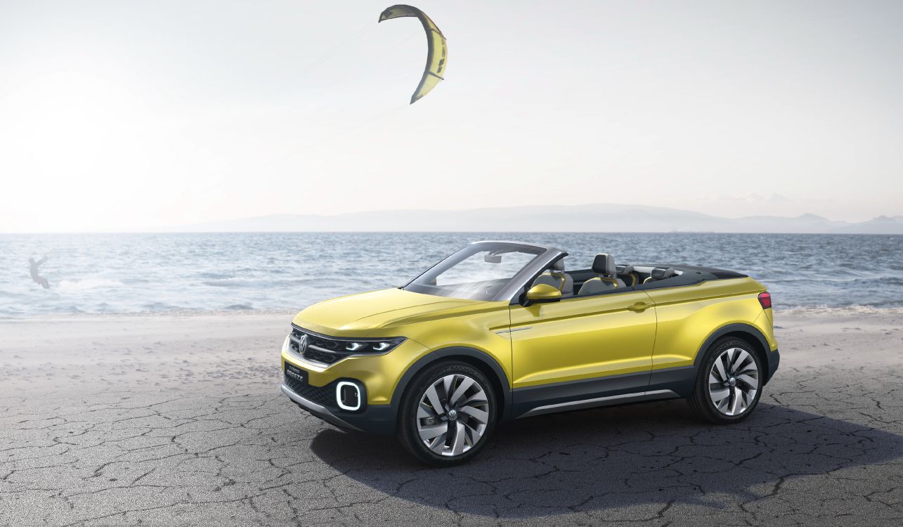 yellow convertible car on gray concrete road during daytime