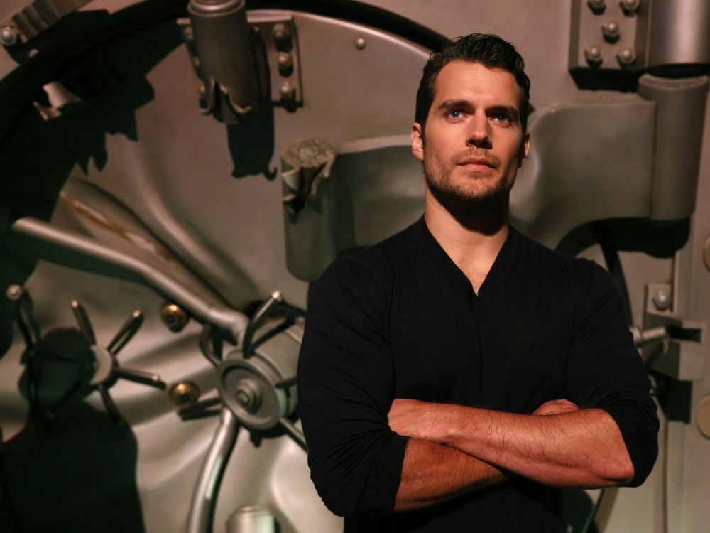 man in black polo shirt sitting on black chair