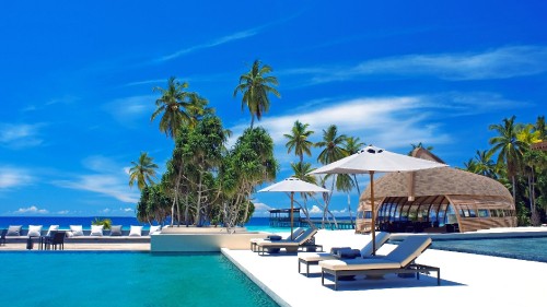 Image white and brown wooden house near swimming pool during daytime