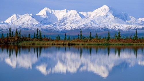 Image lake near trees and snow covered mountain during daytime