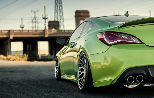 Image green porsche 911 parked on grey pavement during daytime