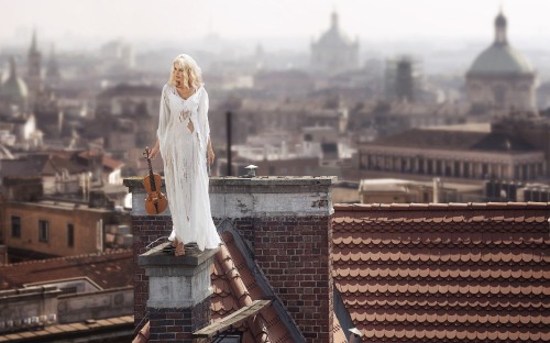 Image woman in white dress statue on top of roof