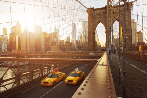 Image yellow car on gray concrete bridge during daytime