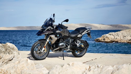 Image black and gray motorcycle on beach during daytime