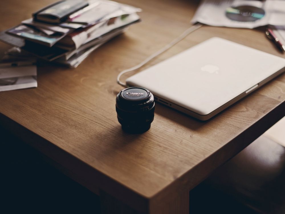 black camera lens on brown wooden table