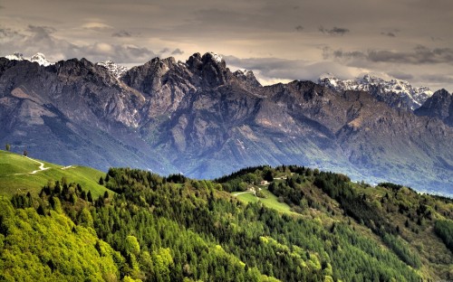 Image green and brown mountains under white clouds during daytime