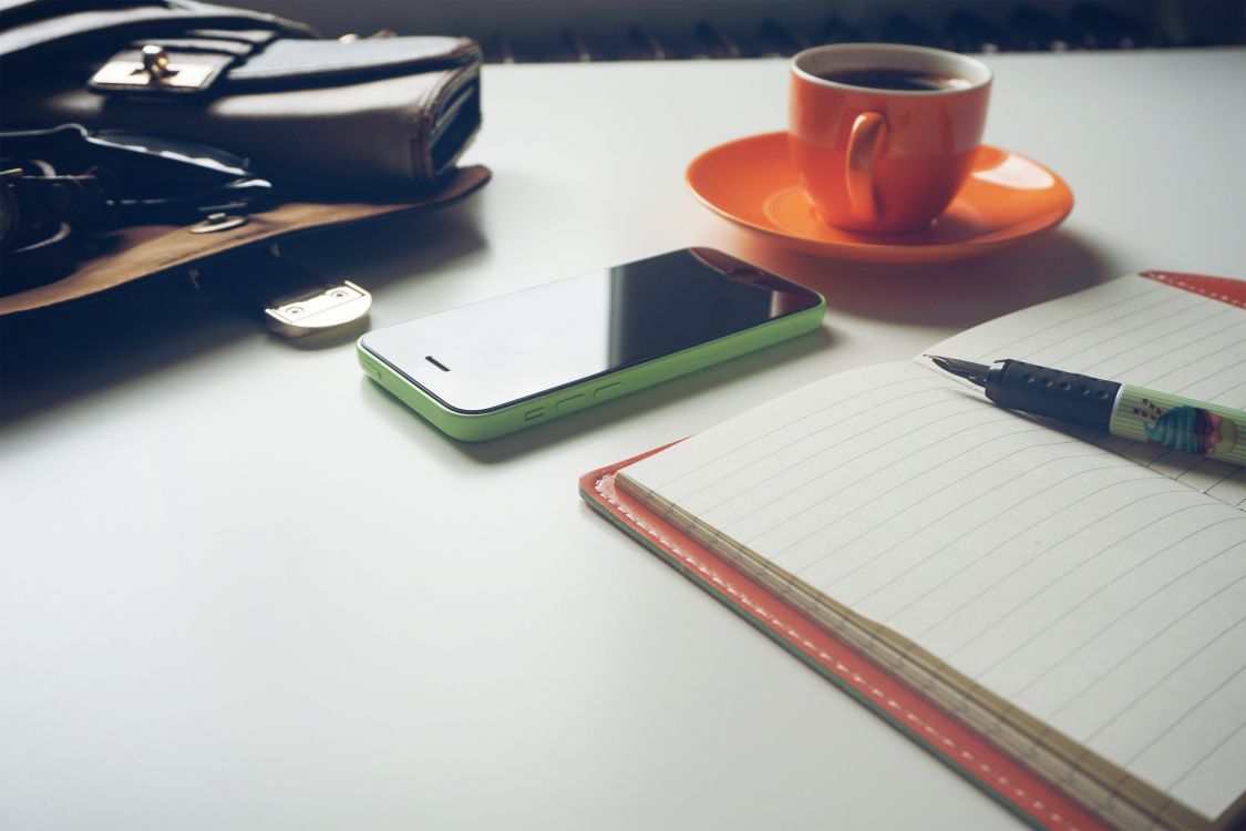 orange ceramic mug on white table