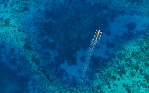 Image aerial view of white boat on body of water during daytime