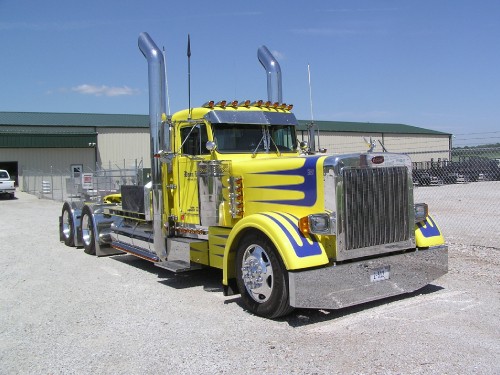 Image yellow truck on gray asphalt road during daytime