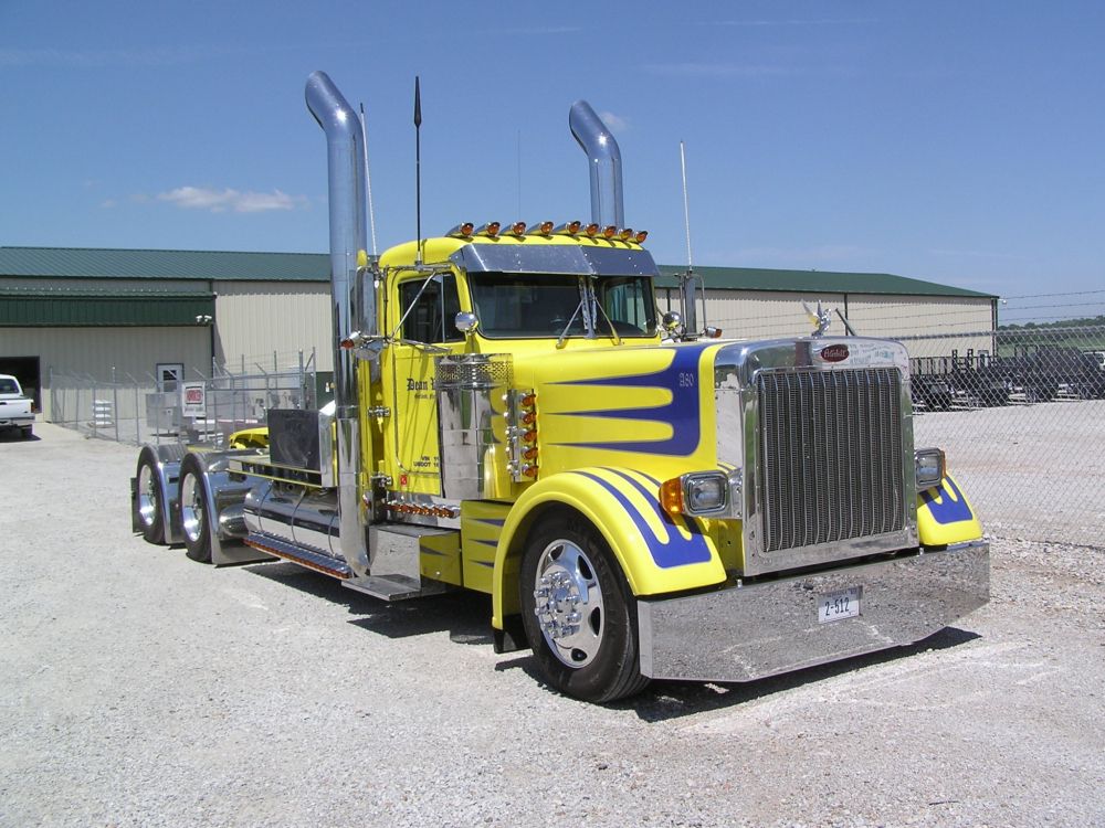 yellow truck on gray asphalt road during daytime