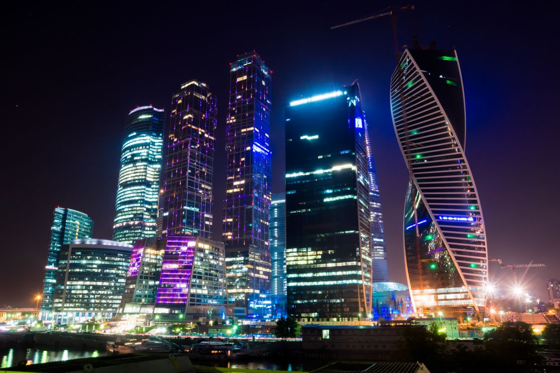 city buildings with lights during night time