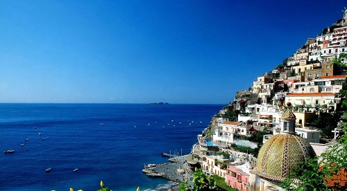 Image aerial view of city buildings near sea during daytime