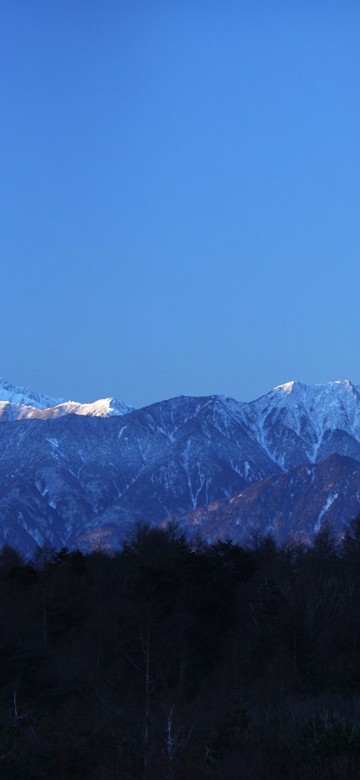 Image snow covered mountain under blue sky during daytime