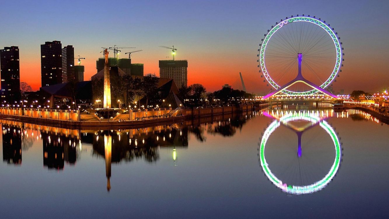 ferris wheel near body of water during night time