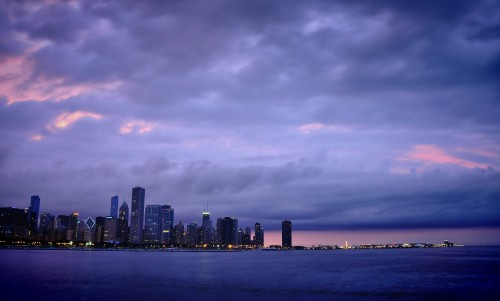 Image city skyline across body of water during daytime