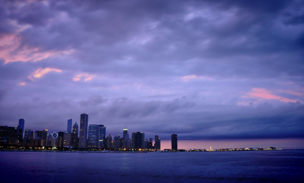 city skyline across body of water during daytime