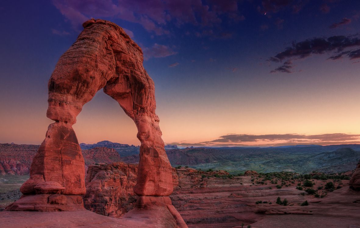 brown rock formation near body of water during daytime