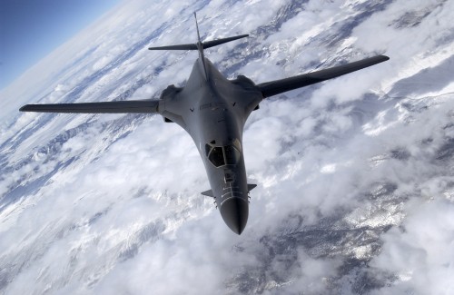 Image gray fighter jet flying over white clouds during daytime