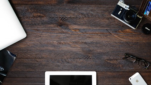 Image white tablet computer on brown wooden table