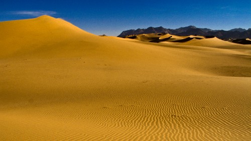 Image brown sand under blue sky during daytime