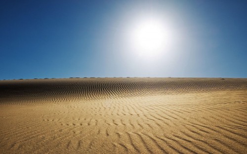 Image brown sand under blue sky during daytime