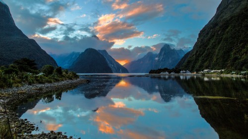 Image lake near mountain under white clouds during daytime