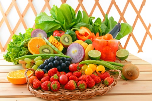 Image red strawberries and green leaves on brown woven basket