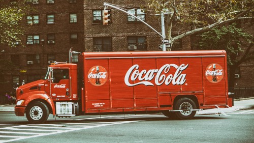 Image red coca cola truck on road during daytime