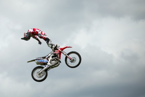 Image man in red and white motocross suit riding motocross dirt bike