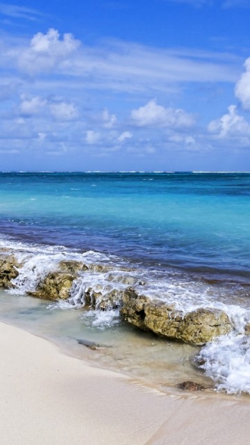 Image sea waves crashing on shore under blue and white cloudy sky during daytime