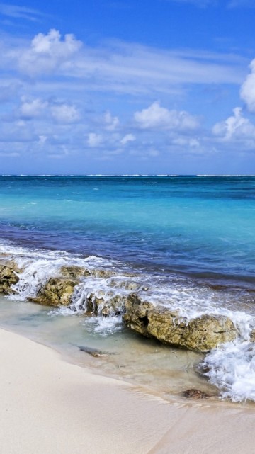 Image sea waves crashing on shore under blue and white cloudy sky during daytime