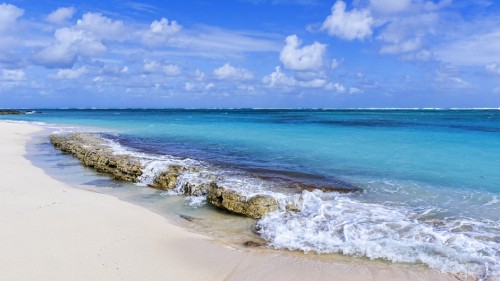 Image sea waves crashing on shore under blue and white cloudy sky during daytime