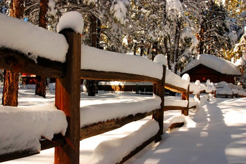 Image brown wooden bench covered with snow