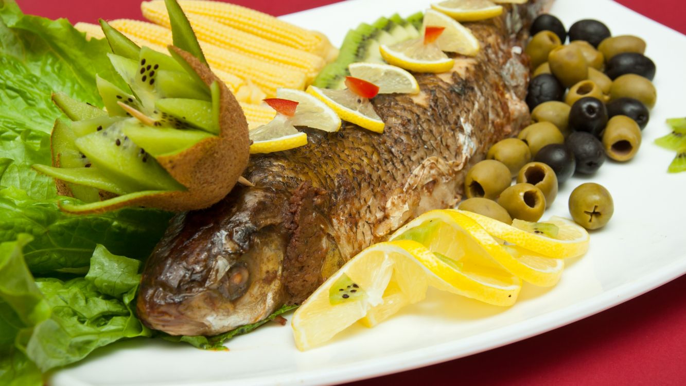 grilled meat with green vegetable on white ceramic plate