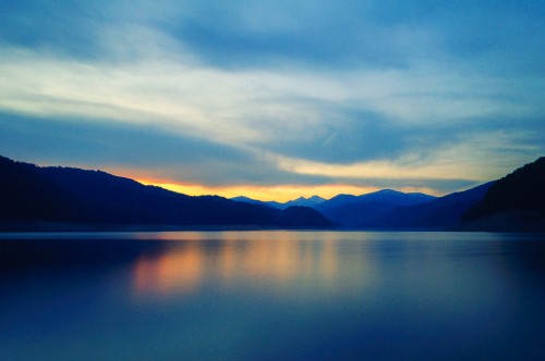 Image body of water near mountain during daytime