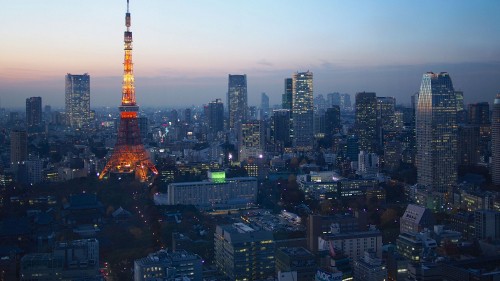 Image orange and white tower in the city during sunset