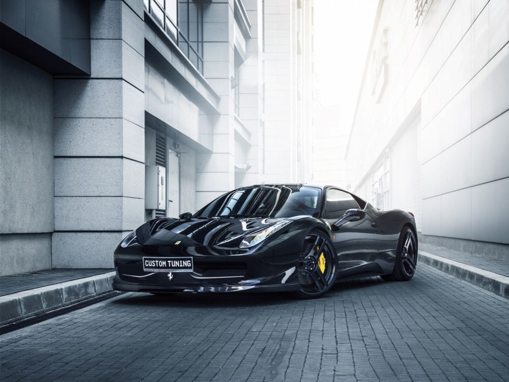 black porsche 911 parked beside white concrete building