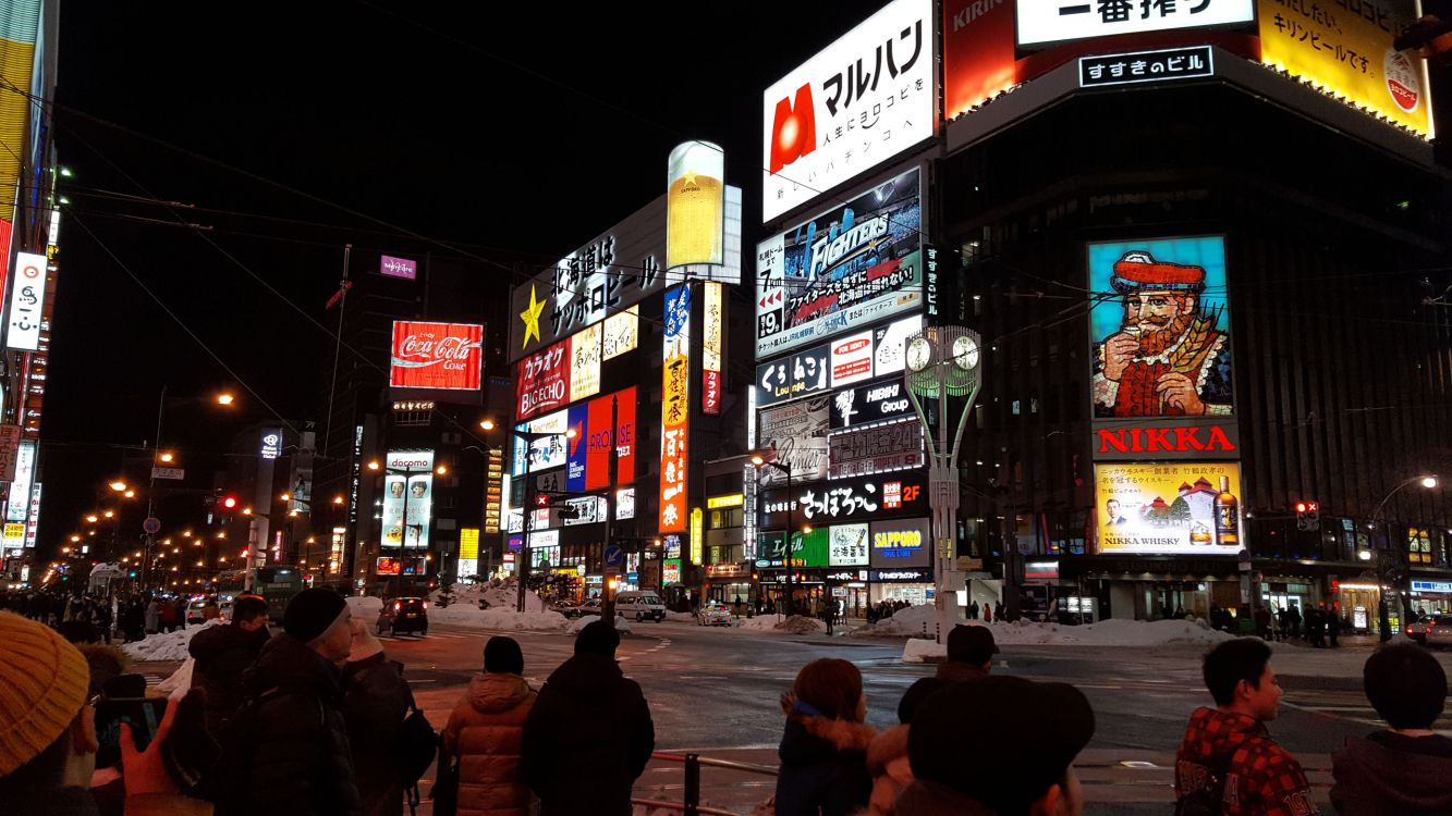 people walking on street during night time