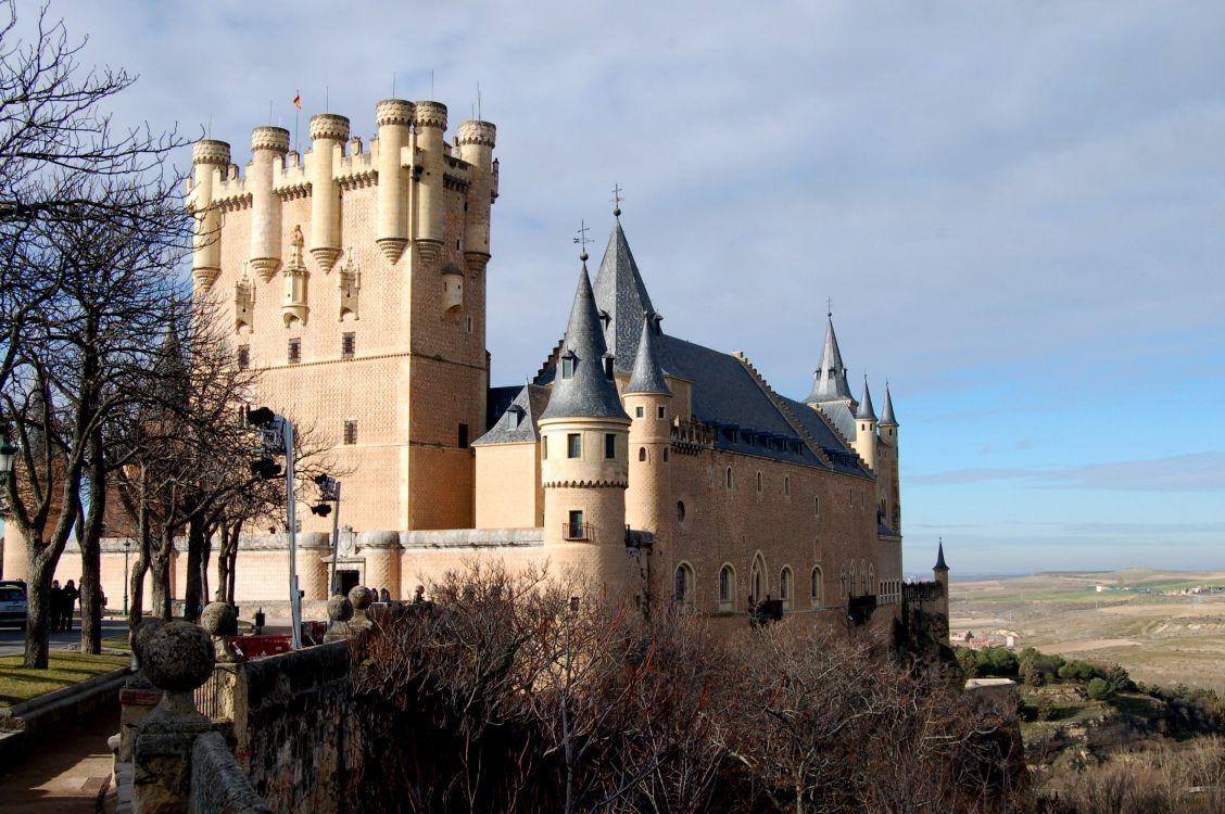 brown concrete castle under white clouds during daytime