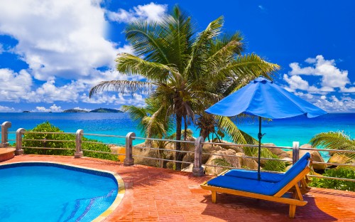 Image blue and brown lounge chairs near swimming pool during daytime