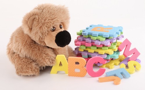 Image brown bear plush toy with multi colored lego blocks