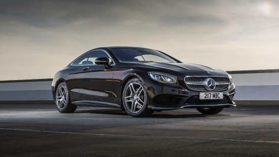Image black mercedes benz coupe on gray asphalt road