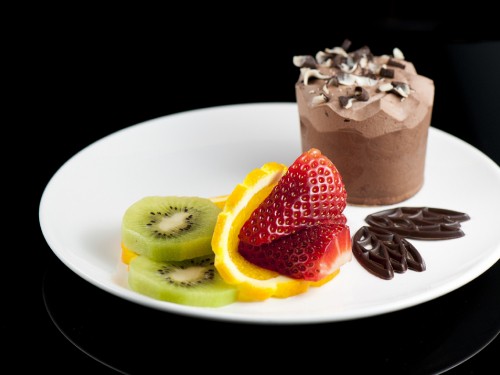 Image sliced of cake with strawberry on white ceramic plate