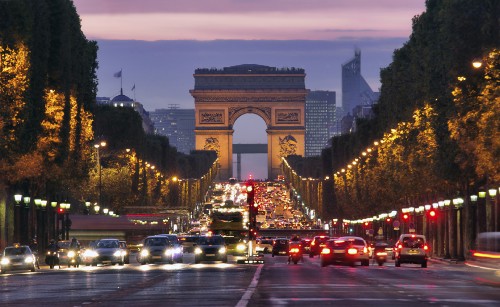 Image cars on road near arch gate during night time