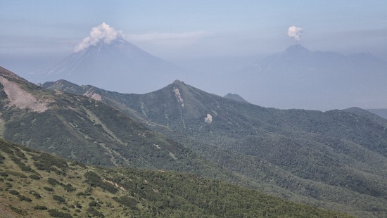 Image green and gray mountain under white clouds during daytime