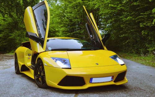 Image yellow ferrari 458 italia parked near green trees during daytime