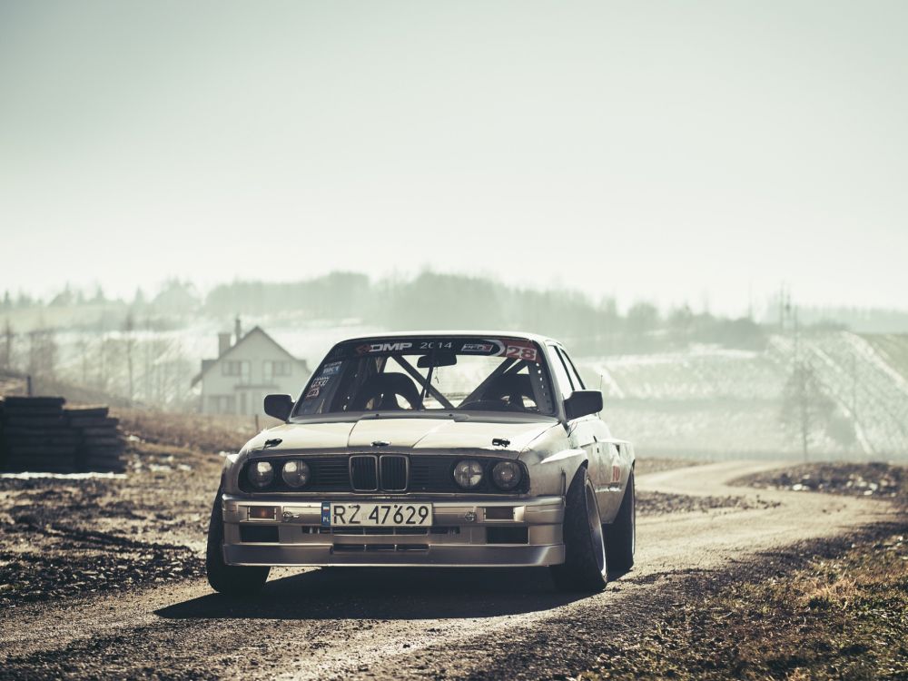 white audi r 8 on dirt road during daytime